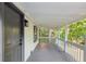 Spacious covered front porch with a gray wood floor, providing a relaxing outdoor space to enjoy the serene surroundings at 4212 Bryan Se Dr, Acworth, GA 30102