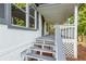 Inviting covered front porch with gray painted steps and rails, adding a touch of charm and a welcoming entrance at 4212 Bryan Se Dr, Acworth, GA 30102