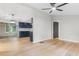 Open-concept kitchen and dining area with sleek, navy blue cabinets, stainless steel appliances, and light wood flooring at 4212 Bryan Se Dr, Acworth, GA 30102