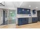 Kitchen boasting stainless steel appliances, navy cabinets, and a screened in porch at 4212 Bryan Se Dr, Acworth, GA 30102