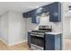 Close-up of the kitchen with stainless steel oven range and blue cabinets at 4212 Bryan Se Dr, Acworth, GA 30102