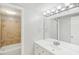 Bathroom with single sink vanity, a large mirror, and tiled shower and tub at 6429 Woodstone Way, Morrow, GA 30260