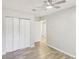 Bedroom features a ceiling fan, three closets, and wood-look floors at 6429 Woodstone Way, Morrow, GA 30260