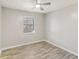Bright bedroom with wood-look floors and neutral colored walls features a window with a view at 6429 Woodstone Way, Morrow, GA 30260