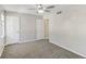 This bedroom features plush carpet, ceiling fan, and bright neutral colored walls at 6429 Woodstone Way, Morrow, GA 30260