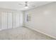 Bright bedroom features neutral decor, a ceiling fan, plush carpeting, and closet for ample storage at 6429 Woodstone Way, Morrow, GA 30260