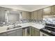 The modern kitchen includes gray cabinets, stainless steel appliances, and a stylish backsplash at 6429 Woodstone Way, Morrow, GA 30260