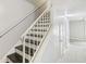 Bright staircase features painted white walls, white banister, and contrasting dark stained stairs at 6429 Woodstone Way, Morrow, GA 30260