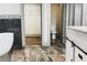 An elegant bathroom with a modern soaker tub, stylish marble floors and a walk-in closet at 664 Florence Nw Pl, Atlanta, GA 30318