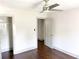 A bedroom has hardwood floors, neutral paint, and a ceiling fan, creating a comfortable space at 664 Florence Nw Pl, Atlanta, GA 30318