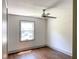 A bright bedroom features hardwood floors, a ceiling fan, and a window bringing in natural light at 664 Florence Nw Pl, Atlanta, GA 30318