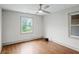 This bedroom offers hardwood floors, natural light, and a ceiling fan at 664 Florence Nw Pl, Atlanta, GA 30318