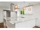 Modern kitchen with stainless steel range hood, granite countertop island, and pendant lighting at 664 Florence Nw Pl, Atlanta, GA 30318