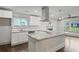 Bright kitchen featuring white cabinetry, granite countertops, and stainless steel appliances at 664 Florence Nw Pl, Atlanta, GA 30318