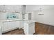A modern kitchen that features white cabinets, granite countertops, and pendant lighting at 664 Florence Nw Pl, Atlanta, GA 30318