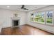 Open living room with hardwood floors, a fireplace, and large windows at 664 Florence Nw Pl, Atlanta, GA 30318