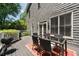 Outdoor living on wooden deck featuring a table, chairs, grill, and backyard views at 1003 North Ne Ave, Atlanta, GA 30306