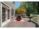 Outdoor living on wooden deck featuring a table, chairs, grill, and backyard views at 1003 North Ne Ave, Atlanta, GA 30306
