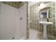 Bathroom featuring floral wallpaper, a pedestal sink, a mirror, and a walk-in shower at 1003 North Ne Ave, Atlanta, GA 30306