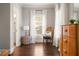 Bedroom view featuring hardwood floors, natural light from the window, and a modern lamp at 1003 North Ne Ave, Atlanta, GA 30306