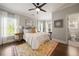 Inviting bedroom with a large windows, ceiling fan, light-colored walls, and a full ensuite bathroom at 1003 North Ne Ave, Atlanta, GA 30306