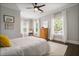 Bright bedroom with a ceiling fan, three windows, and beautiful hardwood floors and a warm area rug at 1003 North Ne Ave, Atlanta, GA 30306