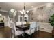 Stylish dining room with modern chandelier, hardwood floors, and open access to staircase at 1003 North Ne Ave, Atlanta, GA 30306