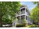 Charming two-story home featuring double porches, white railings, gray siding, and professional landscaping at 1003 North Ne Ave, Atlanta, GA 30306