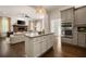 Open concept kitchen featuring granite counters, an island, stainless appliances, and hardwood floors at 1003 North Ne Ave, Atlanta, GA 30306