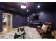 Living room featuring a wall-mounted TV, leather chair, and a modern glass-topped coffee table at 1003 North Ne Ave, Atlanta, GA 30306