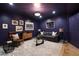 Living room has dark purple walls with light carpeting, modern furniture, and interesting art at 1003 North Ne Ave, Atlanta, GA 30306