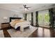 Spacious main bedroom with hardwood floors, a ceiling fan, and private balcony access at 1003 North Ne Ave, Atlanta, GA 30306