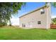 Spacious backyard with lush green lawn, a patio, and a charming wooden fence at 11576 Kades Trl, Hampton, GA 30228