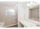 Well-lit bathroom featuring modern vanity, large mirror, and natural light from the window at 11576 Kades Trl, Hampton, GA 30228