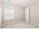 Bright bedroom featuring neutral paint, new carpet, and ample natural light at 11576 Kades Trl, Hampton, GA 30228