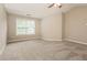 Spacious bedroom featuring new carpet, neutral paint, and window at 11576 Kades Trl, Hampton, GA 30228