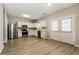 Spacious kitchen featuring white cabinets, stainless steel appliances, and a doorway leading to the backyard at 11576 Kades Trl, Hampton, GA 30228