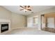 Open-concept living room with fireplace, neutral walls and open access to the dining room and front door at 11576 Kades Trl, Hampton, GA 30228