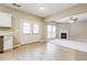 Bright living room with fireplace, neutral paint, and open access to the kitchen and French doors at 11576 Kades Trl, Hampton, GA 30228