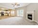 Spacious living room with fireplace, neutral carpet and paint, open to the kitchen and dining room at 11576 Kades Trl, Hampton, GA 30228