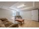 Finished basement with neutral tones, tile floor, comfortable seating, coffee table and a window at 2071 Arrowhead Trl, Marietta, GA 30062