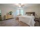 Comfortable bedroom with neutral tones, ceiling fan, carpet, and a decorative chaise lounge and dresser at 2071 Arrowhead Trl, Marietta, GA 30062