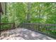 Wooden deck surrounded by lush greenery, perfect for outdoor relaxation and entertaining at 2071 Arrowhead Trl, Marietta, GA 30062