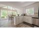 Eat-in kitchen featuring white cabinets, granite countertops, stainless steel appliances, wood floors and a large window at 2071 Arrowhead Trl, Marietta, GA 30062