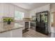 Bright kitchen with stainless steel appliances, granite countertops, white cabinets, and wood-look flooring at 2071 Arrowhead Trl, Marietta, GA 30062
