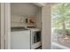 Convenient laundry room equipped with washer, dryer, and exterior view at 2071 Arrowhead Trl, Marietta, GA 30062