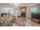 Cozy living room with a stone fireplace, large windows, tile flooring, and stylish furniture at 2071 Arrowhead Trl, Marietta, GA 30062