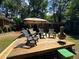 Large wood deck with patio furniture, ideal for outdoor gatherings and overlooking the well-maintained backyard at 224 Sourwood Dr, Marietta, GA 30062