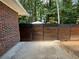 Modern wood and metal fence enclosing a private outdoor space near a brick home exterior at 224 Sourwood Dr, Marietta, GA 30062