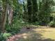 Large backyard with a mix of trees and open space, perfect for outdoor activities at 224 Sourwood Dr, Marietta, GA 30062